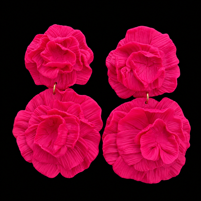 Four bright pink fabric flower earrings arranged in a 2x2 grid against a solid black background.